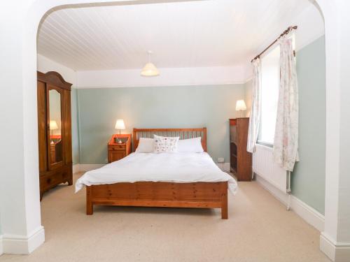 a bedroom with a bed and a window at Rhianfa in Aberdaron