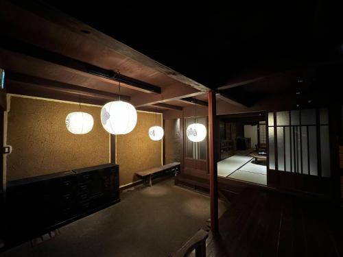 a room with three lights hanging from the ceiling at RITA Yame Fukushima in Yame