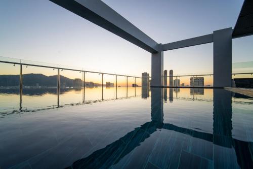 a swimming pool with a view of the water at Luxtery Hotel & Spa in Da Nang