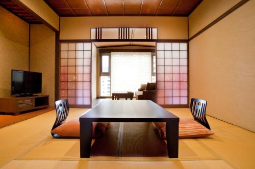 a dining room with a table and two chairs at Yuyado Ichibanchi in Atami