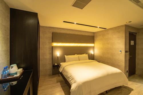 Postel nebo postele na pokoji v ubytování Fengjia Hotel Bell