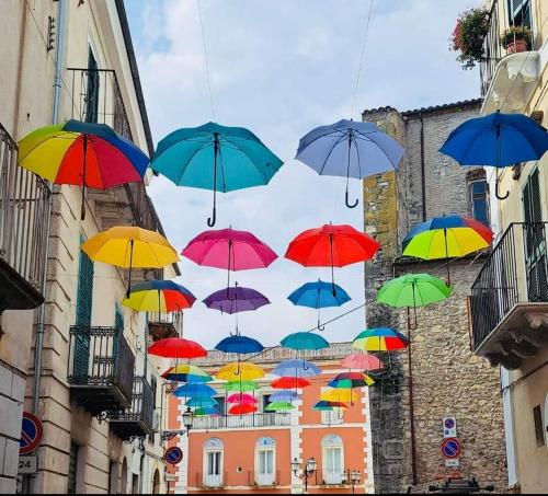 a bunch of colorful umbrellas hanging in the air at B&B NONNA GINA in Manoppello