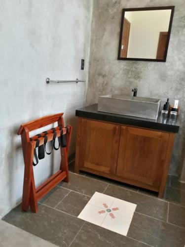 a bathroom with a sink and a mirror at Pink Tulip Hoi An in Hoi An
