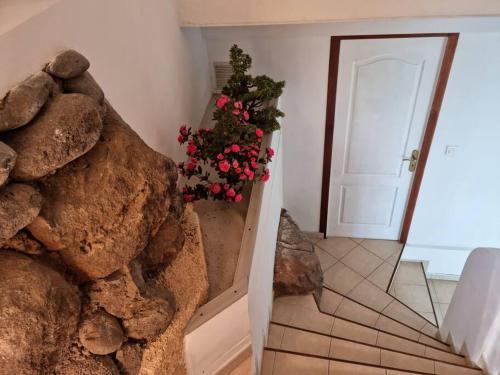 a room with a rock wall next to a door at chez Karine et Robert in Punaauia