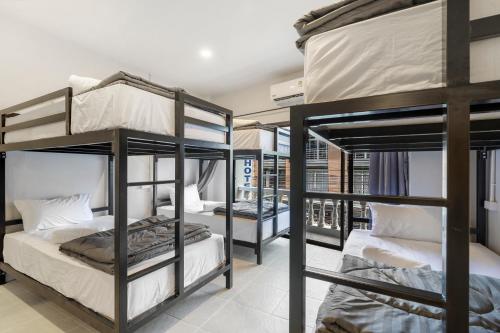 a group of bunk beds in a room at Chill Inn Chaweng Island Cafe and Hostel in Ban Nai Na