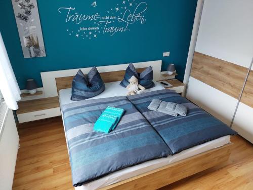 a bed with a teddy bear sitting on top of it at Stilvolle Ferienwohnung im Eichsfeld in Niederorschel