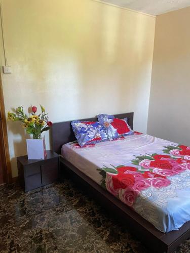 a bedroom with a bed with flowers on it at Riambel Paradise Inn Ground Floor Room in Riambel