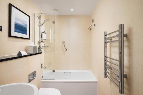 a bathroom with a toilet and a shower and a sink at voco Edinburgh - Royal Terrace by IHG in Edinburgh
