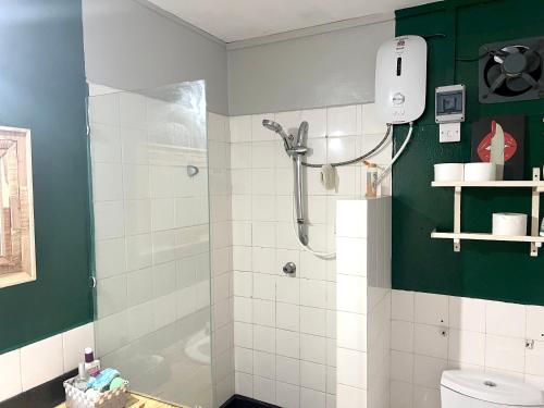 a bathroom with a shower and a toilet at Studio at Grand Baie 100 m away from the beach with shared pool furnished terrace and wifi in Grand Baie
