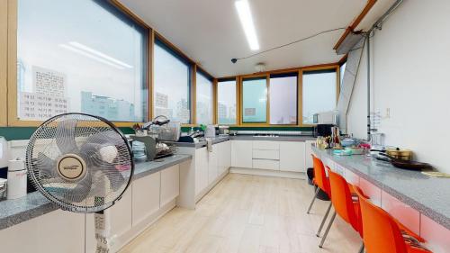 a kitchen with a fan in the middle of a room at dakwan stay in Seoul