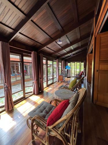 a living room with a couch and a table at Sasitara Thai Villas in Choeng Mon Beach