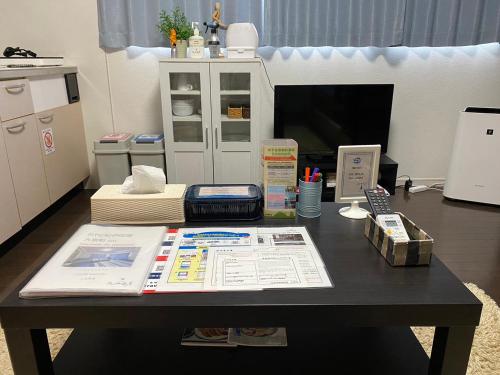an office with a table with papers and a phone at Oyado Kinokuniya Daikokumachi in Nagasaki
