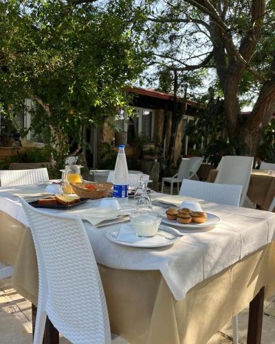 a table with plates of food and bottles of water at Agriturismo Tenuta la Monaca in Aradeo