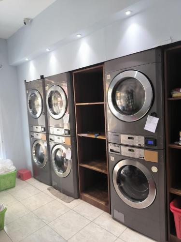 three washing machines in a laundry room at Istanaku in Manado