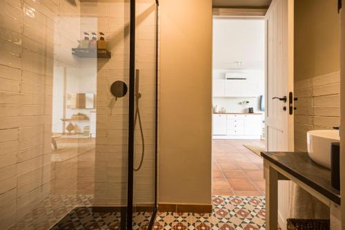 a bathroom with a shower with a glass door at K-NAT by Nuka Homes in Platja de l'Arenal