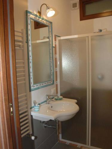 a bathroom with a sink and a shower and a mirror at Reale Wine Resort in Tramonti