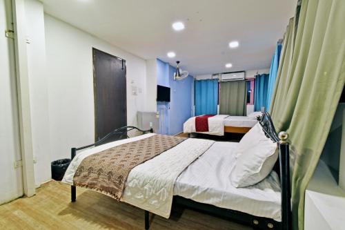 2 camas en una habitación con paredes azules en The Lotus Villa, en Kottakupam
