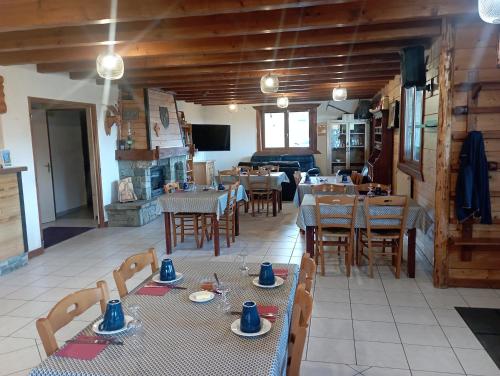 a restaurant with tables and chairs in a room at Chalet Titlis in Bernex