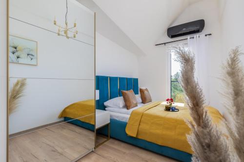 a bedroom with a bed and a mirror at Exclusive Apartment Różana with AC & Balcony View 1 km to the Beach by Renters in Sianozety