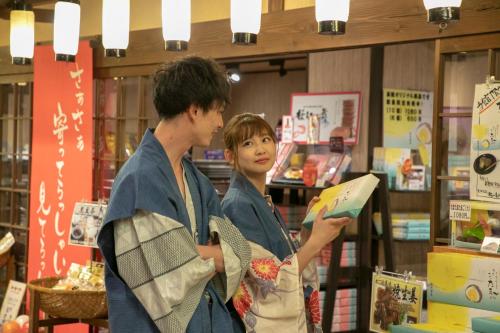 a man and a woman standing in a book store at Yuyado Ichibanchi in Atami