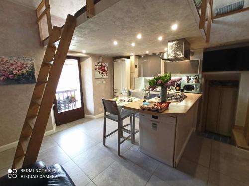 a kitchen with a staircase in a tiny house at Private Romantic Wellness Lake View Retreat- Whirlpool Hammam Spa e Piscina panoramica in Maccagno con Pino e Veddasca