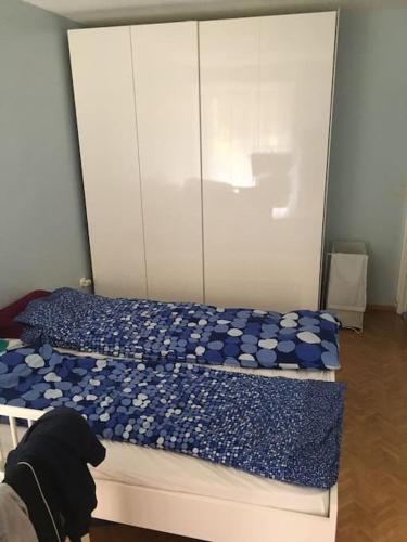 a bedroom with two beds with blue and white sheets at Your home Chaville in Chaville