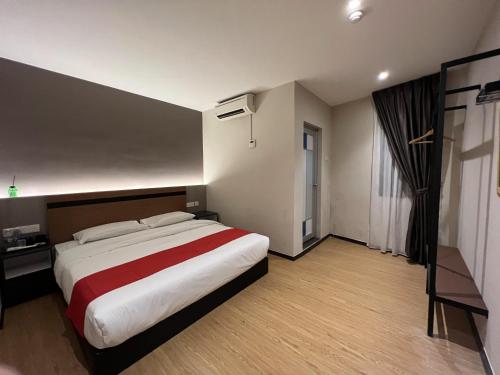 a bedroom with a large bed and a window at GRAND AROMAS in Kulai