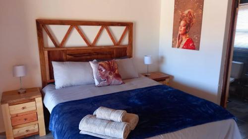 a bedroom with a bed with two towels on it at FLY FISHING PARADISE ON THE VAAL in Parys