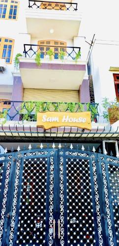 a sign on a gate in front of a building at SAM HOUSE in Phan Thiet