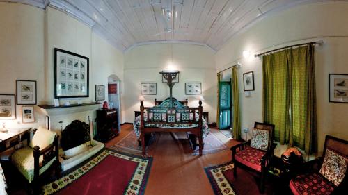 a large living room with a table and chairs at Neemrana's - Ramgarh Bungalows in Rāmgarh