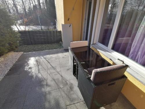 a chair sitting in front of a window at Luxury Voll möblierte 2 Zimmer Appartement Aarau in Küttigen