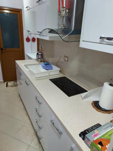 a kitchen with a counter top with a sink at Malaj's Rooms in Sarandë