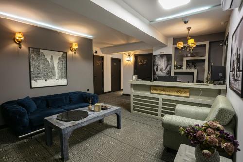 a living room with a blue couch and a table at Monk House in Yerevan