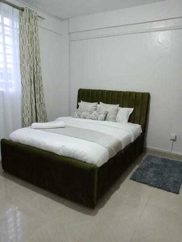 a large bed in a room with at Cloud9 bnb kericho Annex in Kericho