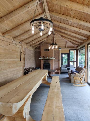 a large wooden table in a room with a living room at Casa Toplita in Topliţa