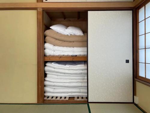 um quarto com um armário cheio de toalhas em ＡＴＴＡ ＨＯＴＥＬ ＫＡＭＡＫＵＲＡ - Vacation STAY 63328v em Kamakura