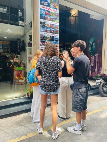 a group of people standing outside of a store at Saigon Hub Hostel in Ho Chi Minh City