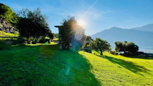 a field of green grass with the sun in the sky at Casa Vacanze La CASA DEL SOLE in Angolo Terme