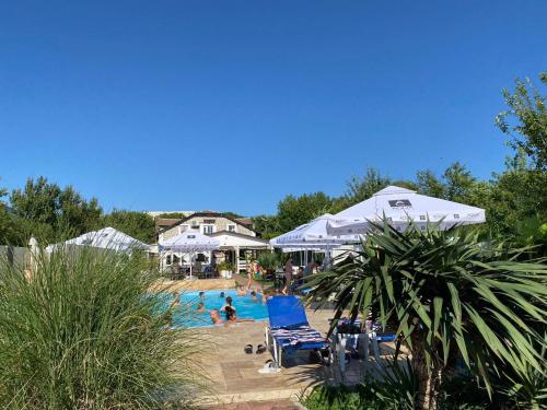 a swimming pool with people in a resort at ElGringo Clisura Dunarii in Moldova Nouă
