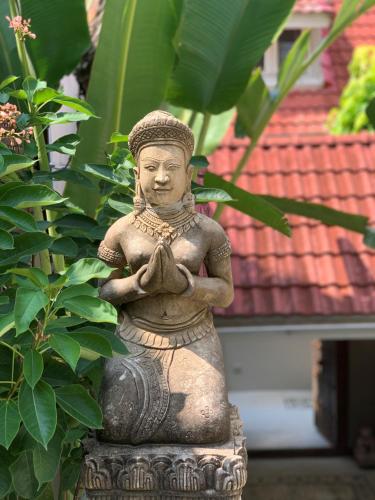a statue of a person in a meditation pose at Beachfront Villa Charmant With Private Pool in Koh Samui 