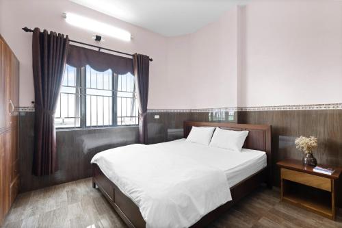 Postel nebo postele na pokoji v ubytování Mộc Nhiên Hotel Da Nang