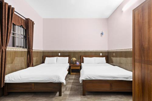 Postel nebo postele na pokoji v ubytování Mộc Nhiên Hotel Da Nang