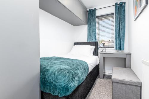 a bedroom with a bed and a desk and a window at Marham Close in Nottingham
