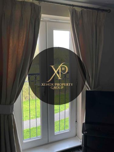 a window with a kenton photography shoot sign on it at Peaceful 3 BR Flat with A View Near Hospitals-Free Parking in Newcastle under Lyme