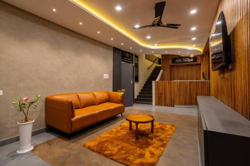 a living room with a couch and a table at MERIDIAN BY Daan in Trivandrum