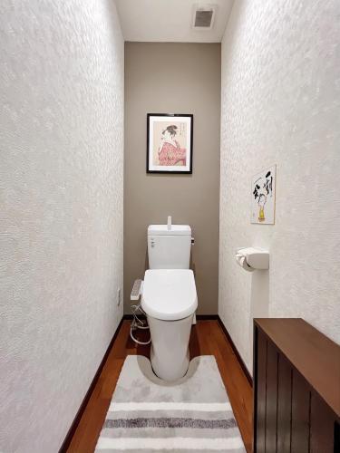 a bathroom with a white toilet in a room at 千間川-緑橋 in Osaka