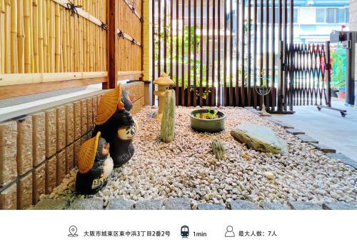 a stuffed animal is sitting next to a fence at 千間川-緑橋 in Osaka