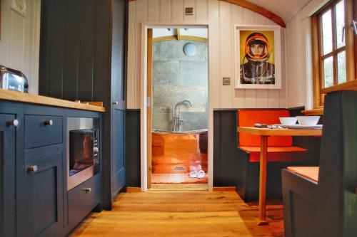 a kitchen with a door leading to a bathroom with a tub at The Garden Rooms at Lonton in Durham