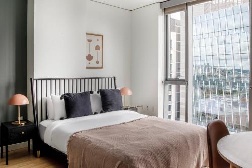 a bedroom with a large bed and a large window at Pioneer Square studio w gym bbq nr stadium SEA-586 in Seattle