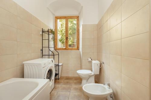a bathroom with a toilet and a tub and a sink at City port Apartment in Herceg-Novi